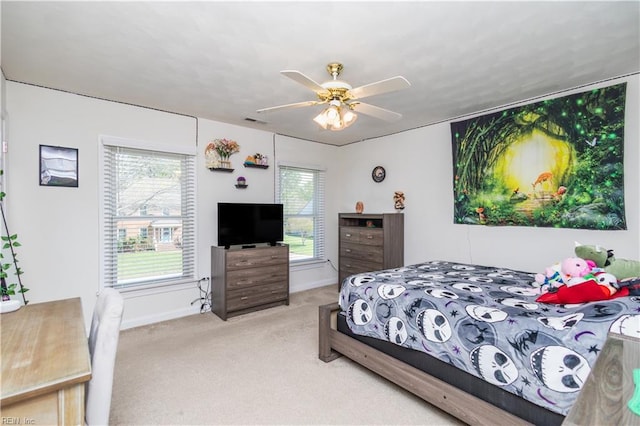 bedroom featuring light colored carpet, a ceiling fan, baseboards, and visible vents