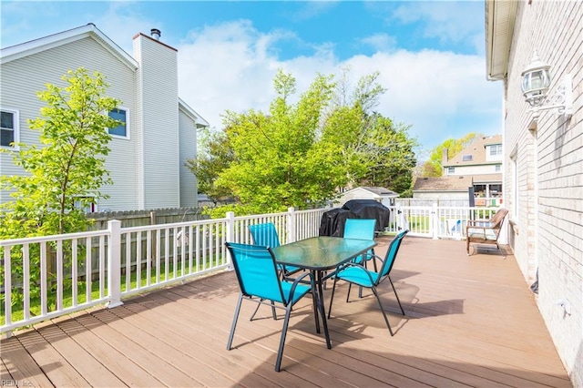 deck featuring a fenced backyard and outdoor dining area