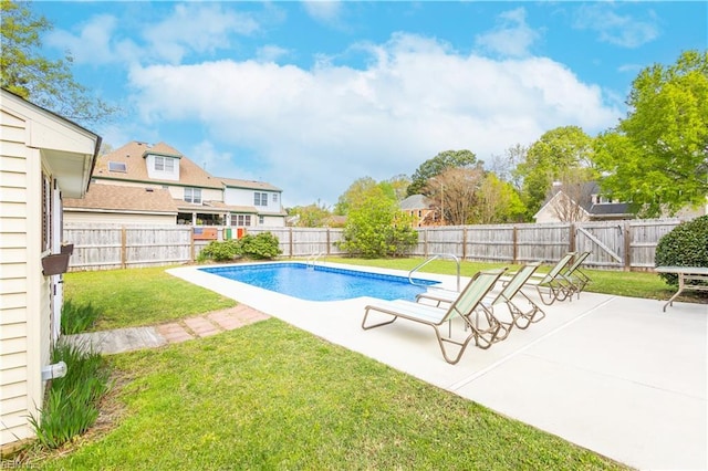 view of swimming pool featuring a fenced backyard, a patio, and a yard