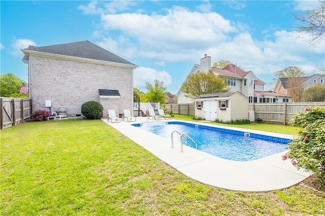 view of swimming pool with a fenced in pool, an outdoor structure, a shed, a fenced backyard, and a yard