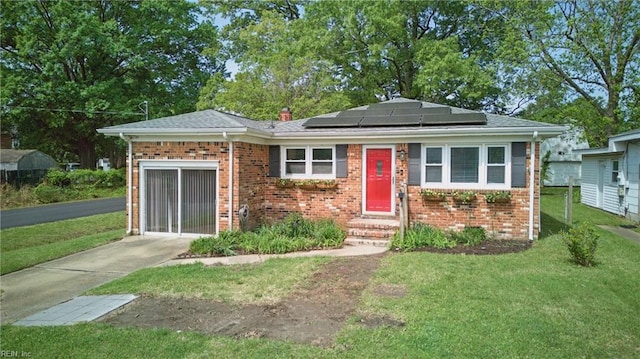 1619 Linden Ave, Chesapeake, VA 23325 - view of front of property featuring roof mounted solar panels, a front lawn, roof with shingles, and brick siding