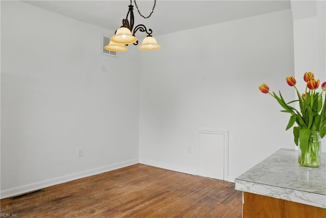 1619 Linden Ave, Chesapeake, VA 23325 - unfurnished dining area featuring baseboards, visible vents, wood finished floors, and an inviting chandelier
