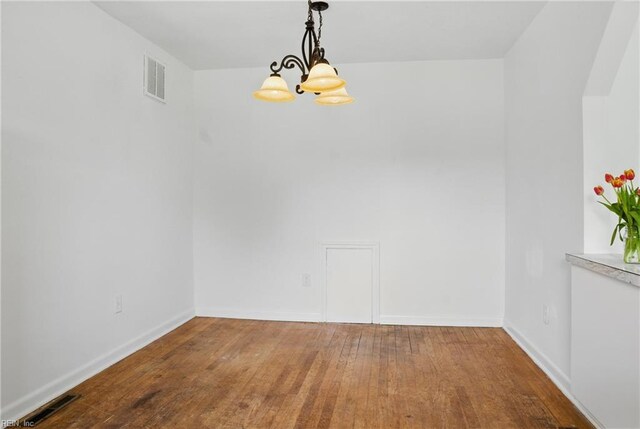 1619 Linden Ave, Chesapeake, VA 23325 - unfurnished dining area featuring a chandelier, visible vents, wood finished floors, and baseboards