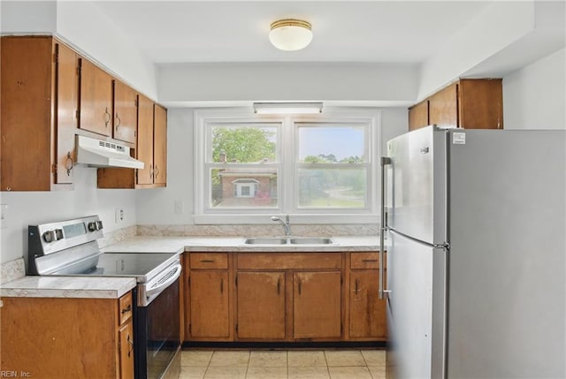 1619 Linden Ave, Chesapeake, VA 23325 - kitchen featuring a sink, appliances with stainless steel finishes, light countertops, under cabinet range hood, and brown cabinetry