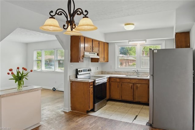 1619 Linden Ave, Chesapeake, VA 23325 - kitchen featuring electric stove, a sink, freestanding refrigerator, and brown cabinetry