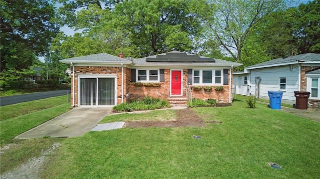 1619 Linden Ave, Chesapeake, VA 23325 - view of front of house with a front yard, solar panels, entry steps, and brick siding