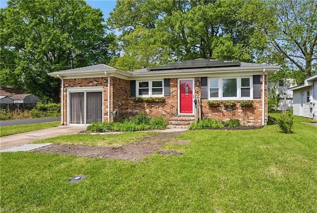 1619 Linden Ave, Chesapeake, VA 23325 - view of front of house with a front yard, brick siding, concrete driveway, solar panels, and an attached garage