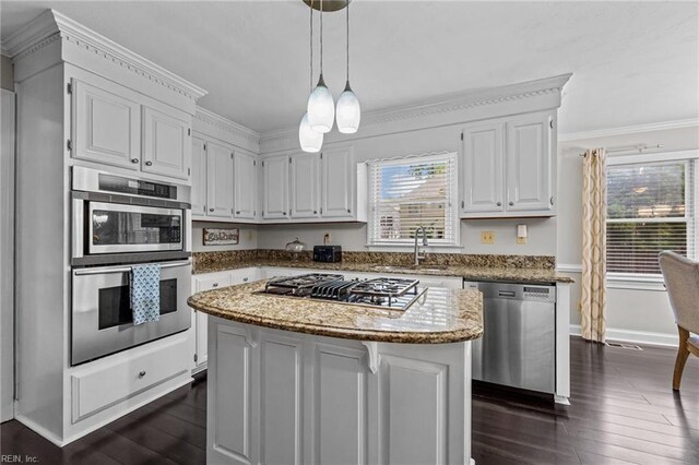 kitchen featuring light stone counters, a sink, stainless steel appliances, white cabinetry, and dark wood-type flooring