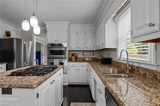kitchen featuring a sink, appliances with stainless steel finishes, and white cabinets