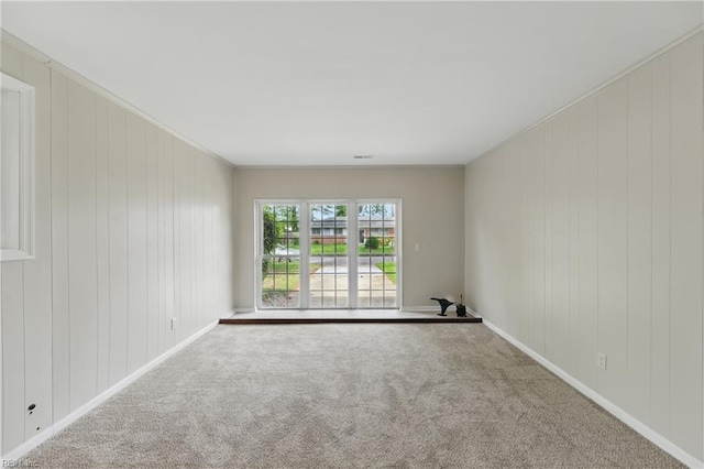 unfurnished room featuring baseboards and carpet flooring