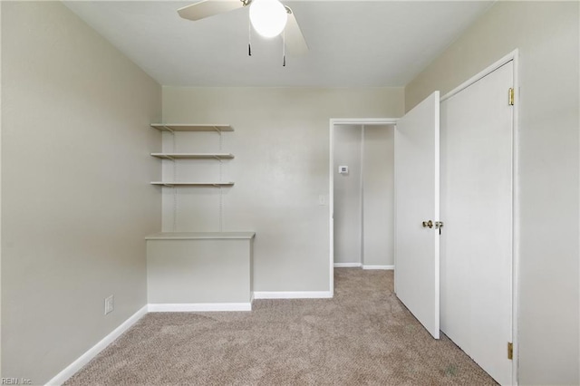 unfurnished bedroom featuring a ceiling fan, carpet flooring, a closet, and baseboards