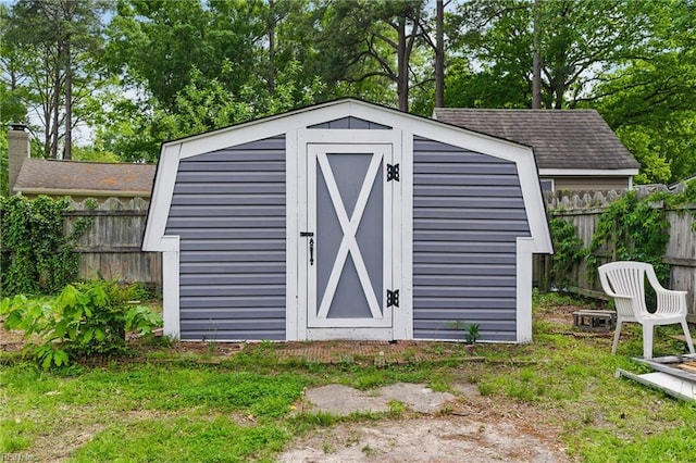 view of shed featuring fence