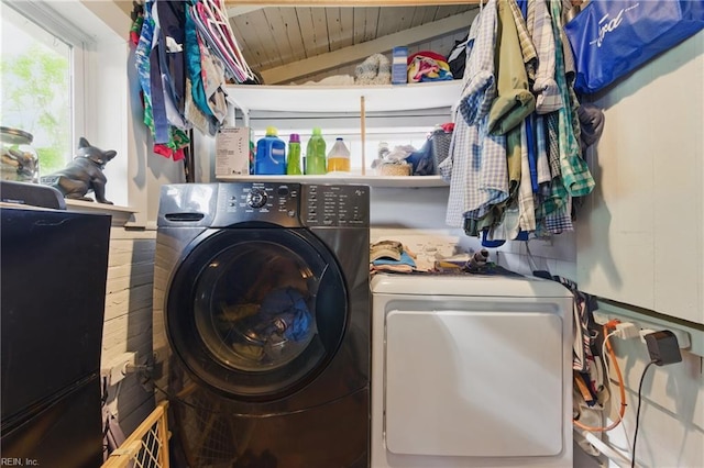washroom featuring washing machine and clothes dryer, laundry area, and wood ceiling