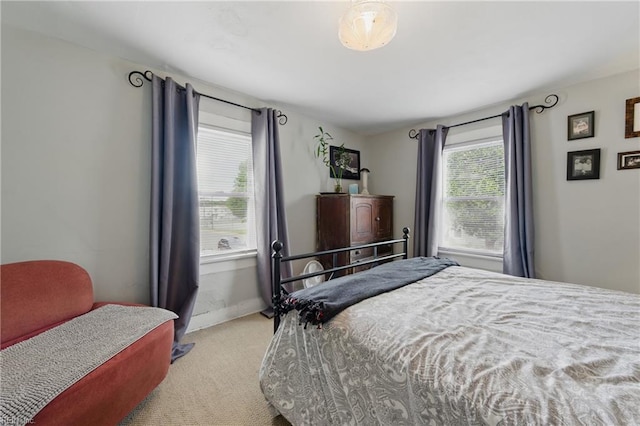 carpeted bedroom with baseboards