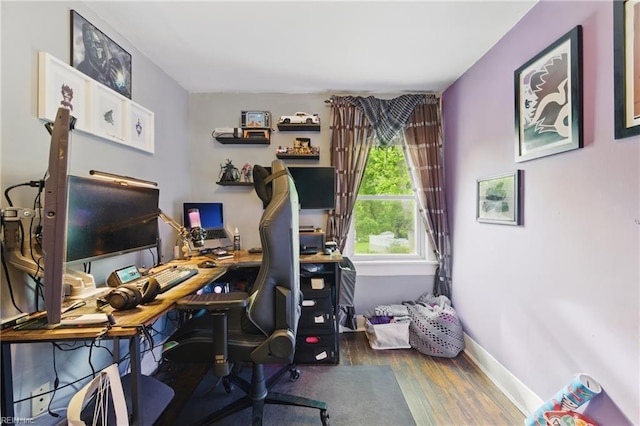 home office featuring baseboards and wood finished floors