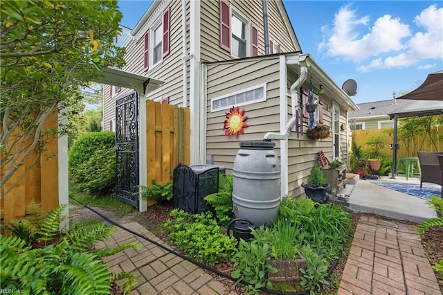view of home's exterior featuring fence and a patio area