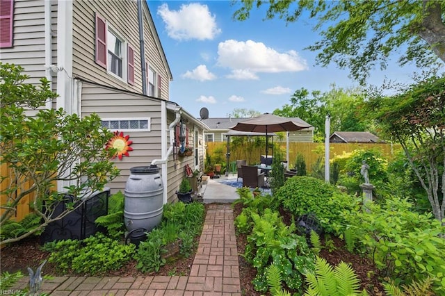 view of yard featuring fence and a patio area
