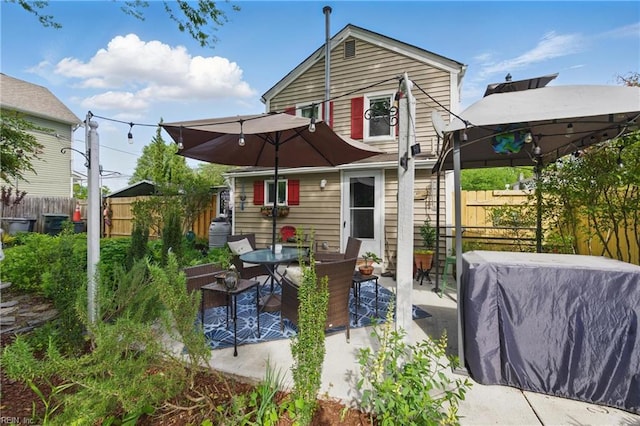 back of property with a patio and a fenced backyard
