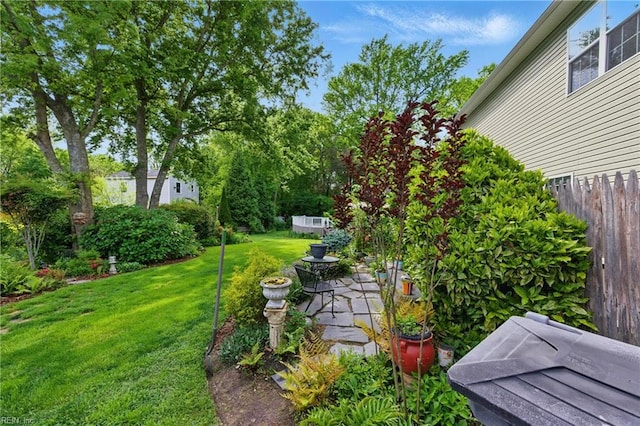 view of yard with fence and a patio