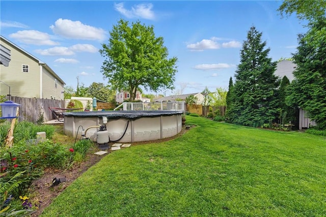 view of yard featuring fence and a fenced in pool