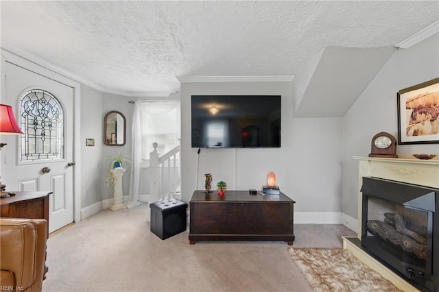 carpeted living area with a fireplace, a textured ceiling, crown molding, and baseboards
