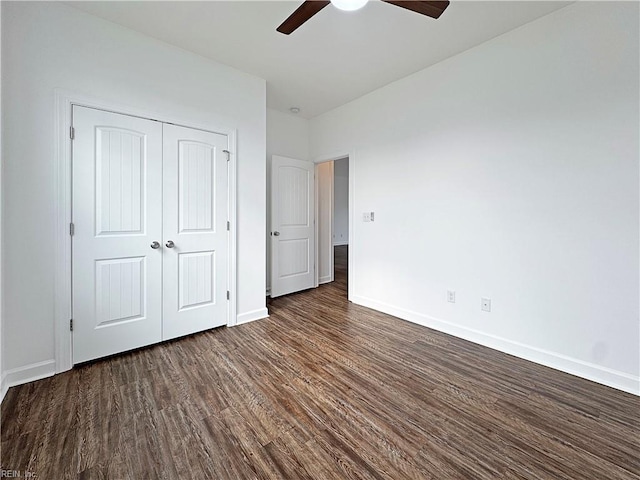 unfurnished bedroom featuring dark wood finished floors, baseboards, ceiling fan, and a closet