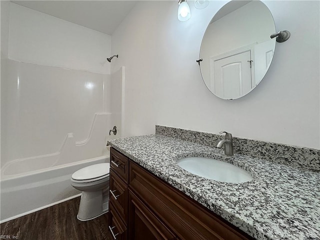 full bath featuring toilet, vanity, shower / bathtub combination, and wood finished floors