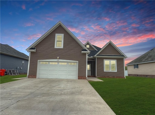 traditional-style home featuring a front lawn, driveway, and an attached garage