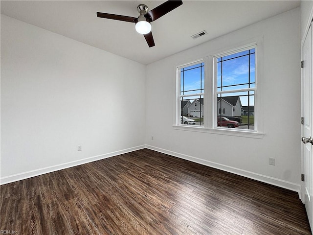 unfurnished room featuring baseboards, visible vents, a ceiling fan, and dark wood-type flooring