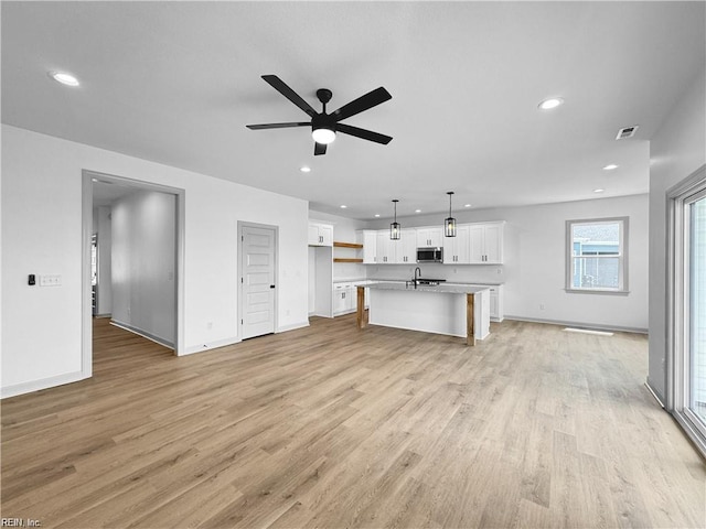 unfurnished living room featuring visible vents, ceiling fan, recessed lighting, and light wood-style floors
