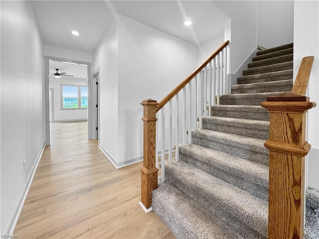 stairs featuring baseboards, recessed lighting, wood finished floors, and a ceiling fan