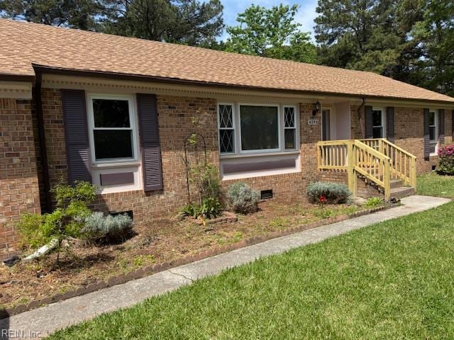 ranch-style house featuring a front yard, crawl space, a shingled roof, and brick siding