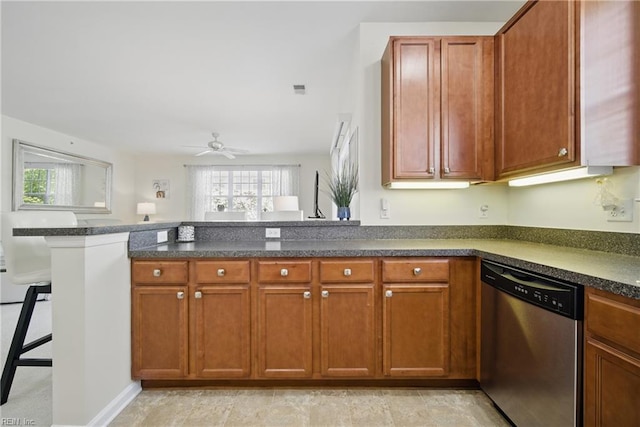 kitchen with stainless steel dishwasher, a peninsula, a breakfast bar, ceiling fan, and brown cabinets