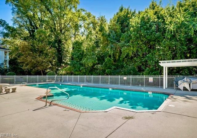 pool featuring fence and a patio