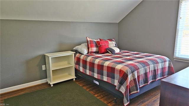 bedroom with baseboards and wood finished floors