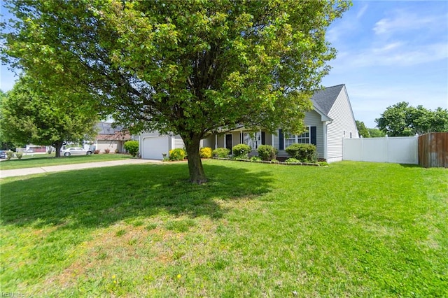 obstructed view of property featuring fence, driveway, an attached garage, and a front yard