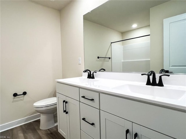 150 Mcpherson Rd, South Mills, NC 27976 - full bath featuring baseboards, wood finished floors, toilet, and a sink