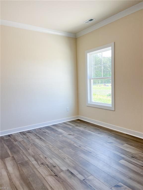 150 Mcpherson Rd, South Mills, NC 27976 - empty room featuring dark wood finished floors, visible vents, crown molding, and baseboards