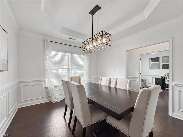 dining space with dark wood-style flooring and a decorative wall