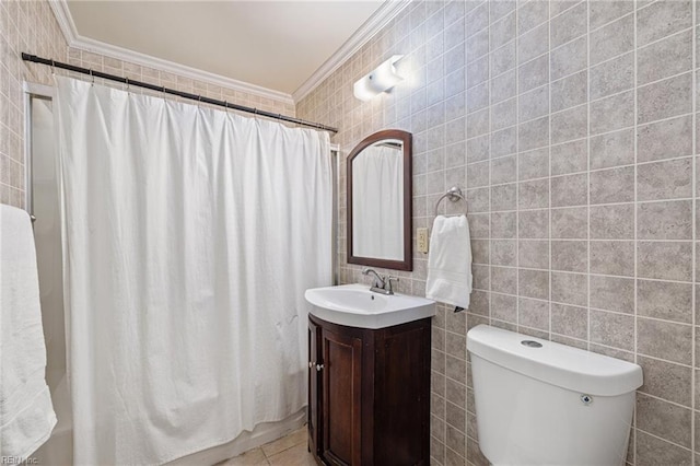 bathroom with tile walls, ornamental molding, toilet, and vanity