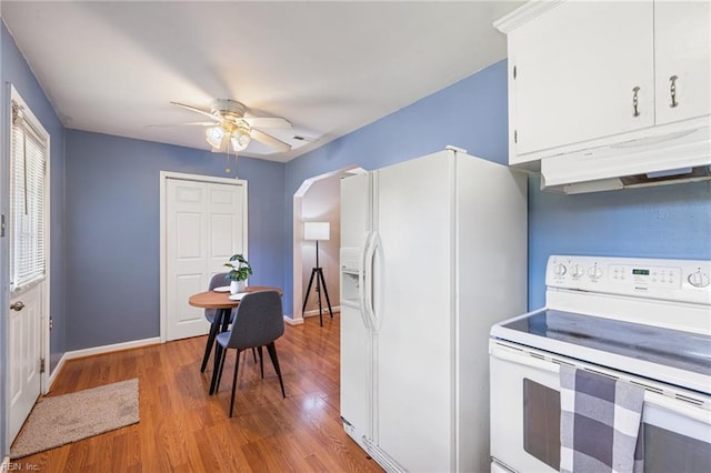 kitchen with light wood-style flooring, ceiling fan, baseboards, under cabinet range hood, and white appliances