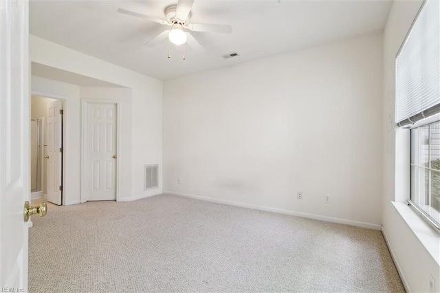 unfurnished room featuring carpet floors, ceiling fan, and baseboards