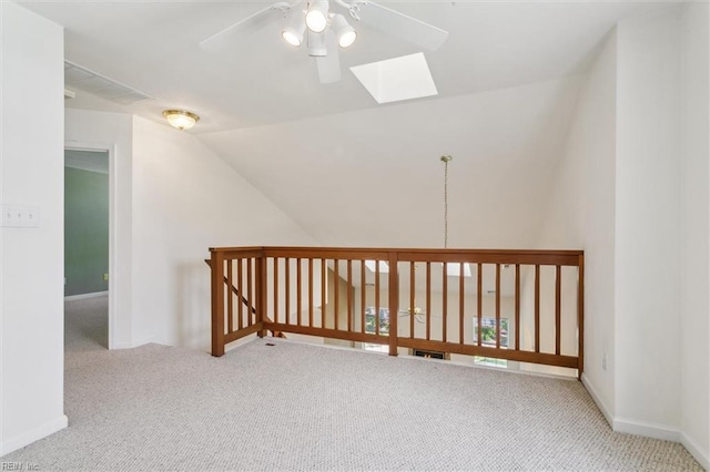 bonus room with ceiling fan, carpet floors, a skylight, lofted ceiling, and baseboards