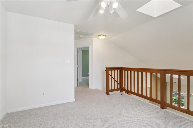 bonus room featuring carpet flooring, ceiling fan, a skylight, lofted ceiling, and baseboards