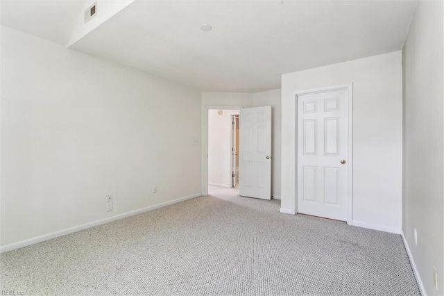 unfurnished bedroom with light colored carpet and baseboards