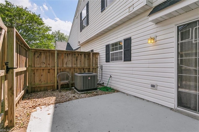 view of patio / terrace featuring central air condition unit and fence