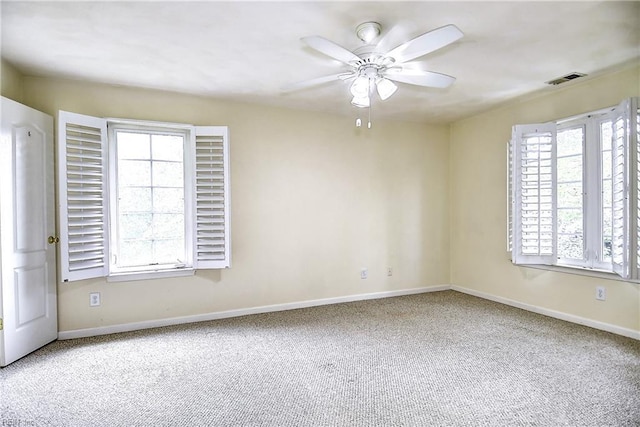 unfurnished room featuring visible vents, carpet flooring, ceiling fan, and baseboards