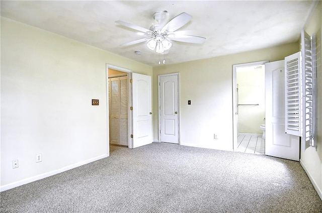 unfurnished bedroom featuring baseboards, a ceiling fan, connected bathroom, and carpet flooring