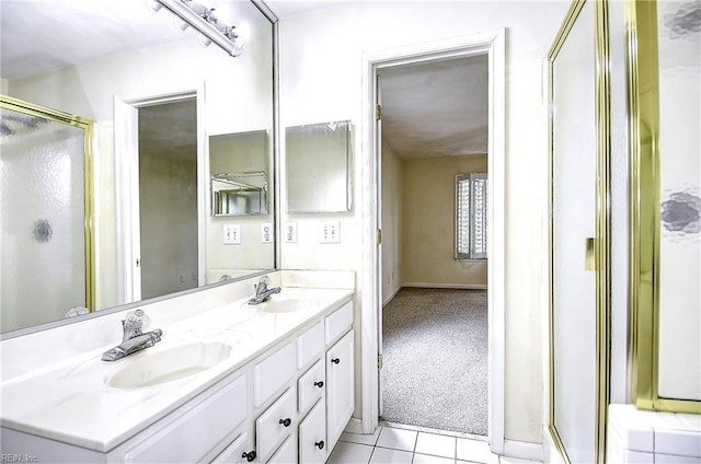 bathroom with tile patterned floors, a stall shower, double vanity, and a sink