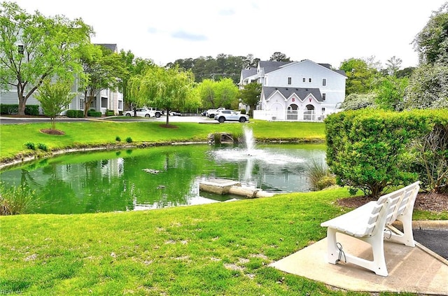 view of home's community with a yard and a water view